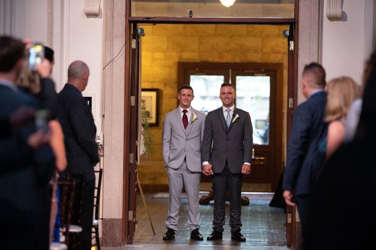 grooms walk down the aisle