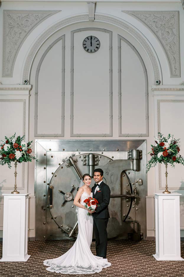 Bride and groom standing outside of the Treasury vault for their wedding photos