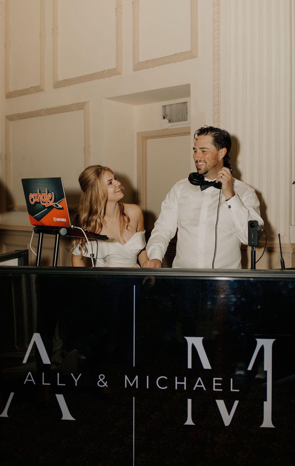 Ally and Michael helped out behind the DJ booth at their reception. | Photo: Barbara Ann