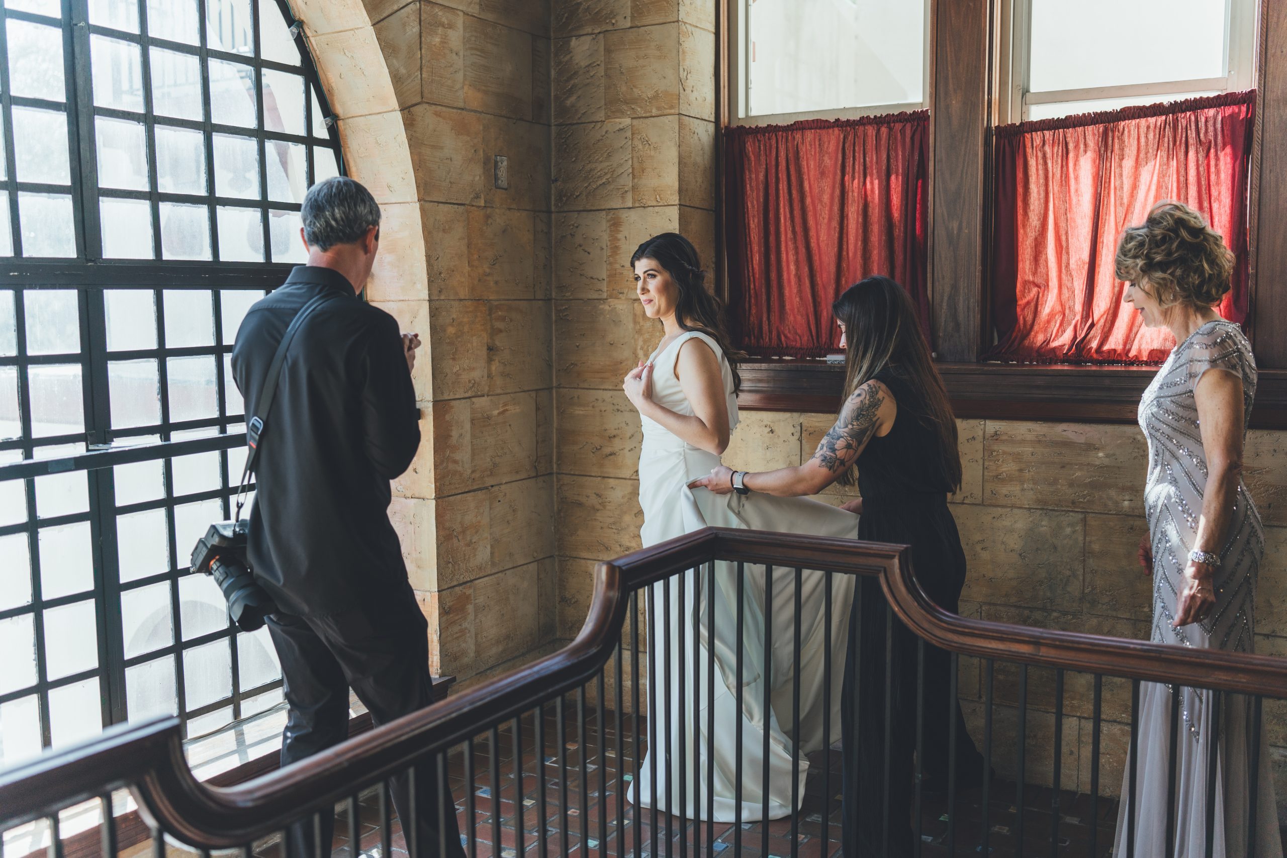 A bride at The Treasury on the Plaza with their planner and photographer. | Photo: Southern Palms Studio