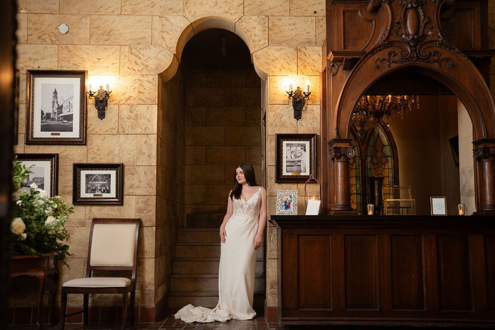 Bride descending the staircase inside The Treasury on the Plaza.