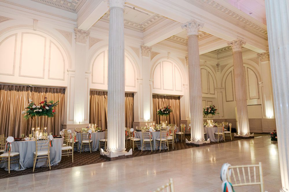 Reception space with floral centerpieces inside The Treasury on the Plaza.