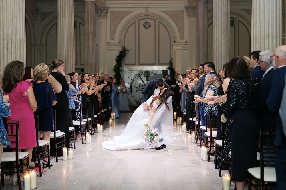 Bride and Groom walking down the aisle in the Grand Ballroom at The Treasury on the Plaza