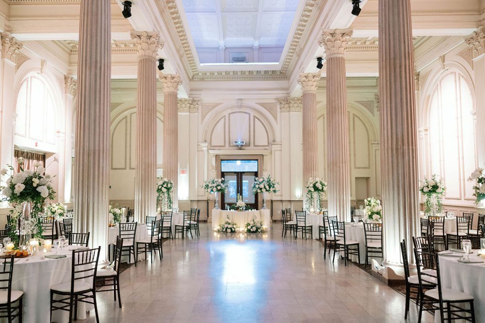 Reception dining tables arranged inside The Treasury on the Plaza.